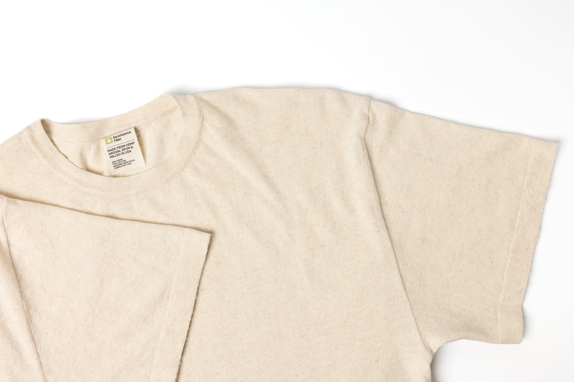 Beige t-shirt with a label on a white background
